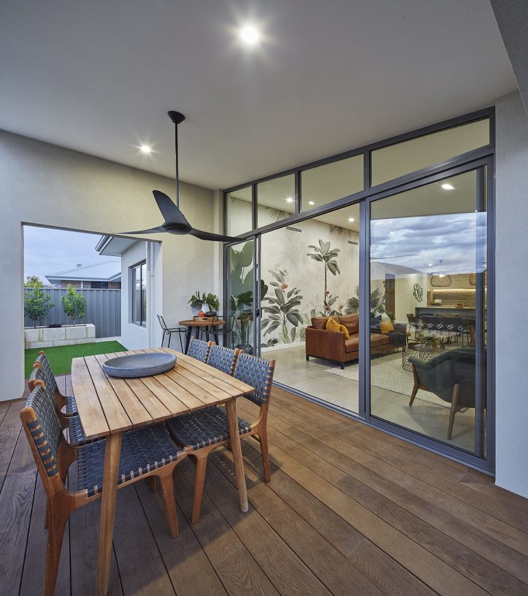Large glazed doors connecting a modern home with an outdoor living area.