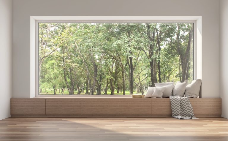Floor-to-ceiling toughened glass window overlooking a green garden