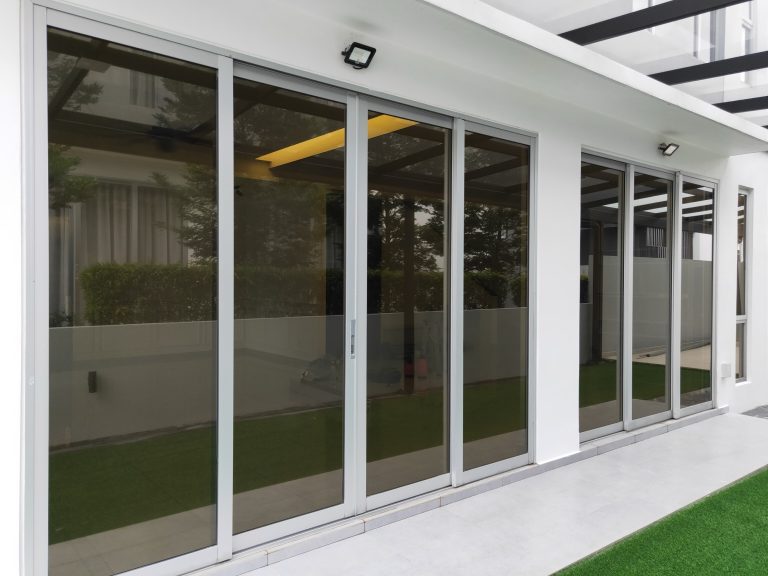 Grey tinted glass sliding doors on a modern home exterior