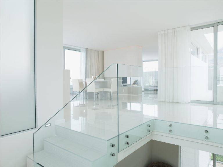 Ultra clear toughened glass balustrade on a white staircase landing